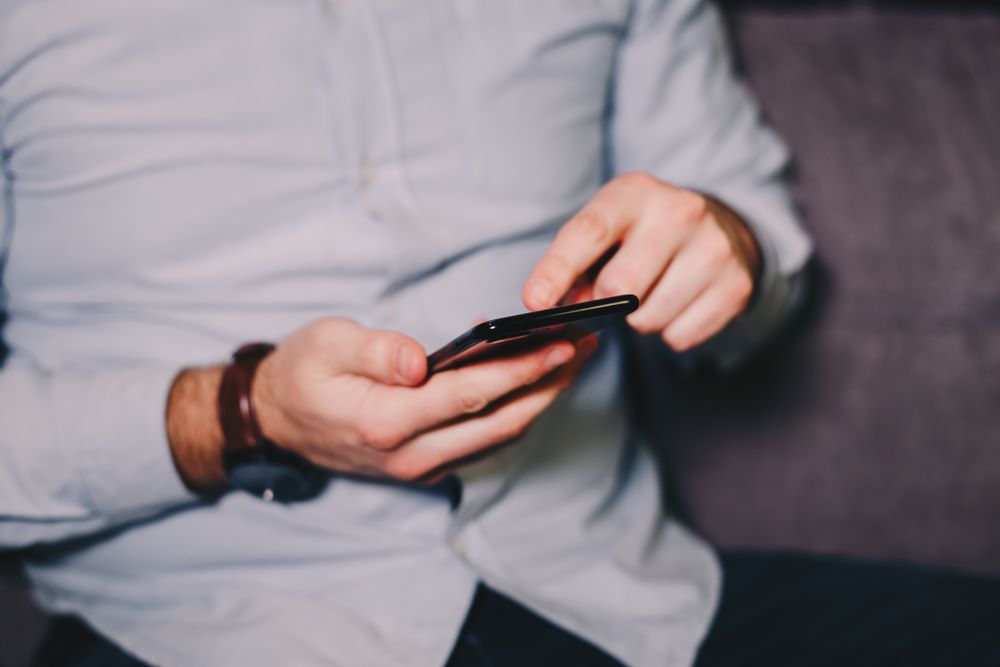 man texting on cell phone