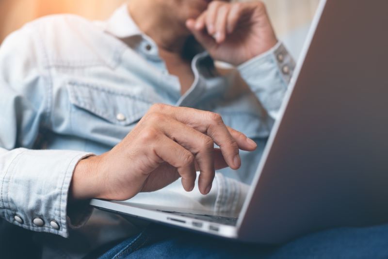 man messaging someone on his computer