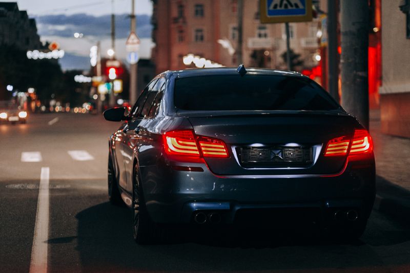 Sedan driving down the street at night